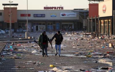 Members of a private security walk at a looted shopping mall as the country deploys army to quell unrest linked to the jailing of former South African President Jacob Zuma, in Vosloorus, South Africa, July 14, 2021. REUTERS/Siphiwe Sibeko