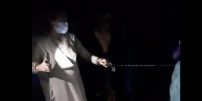 Numina Begum being taken to her child's funeral in handcuffs. Photo: Screengrab from video